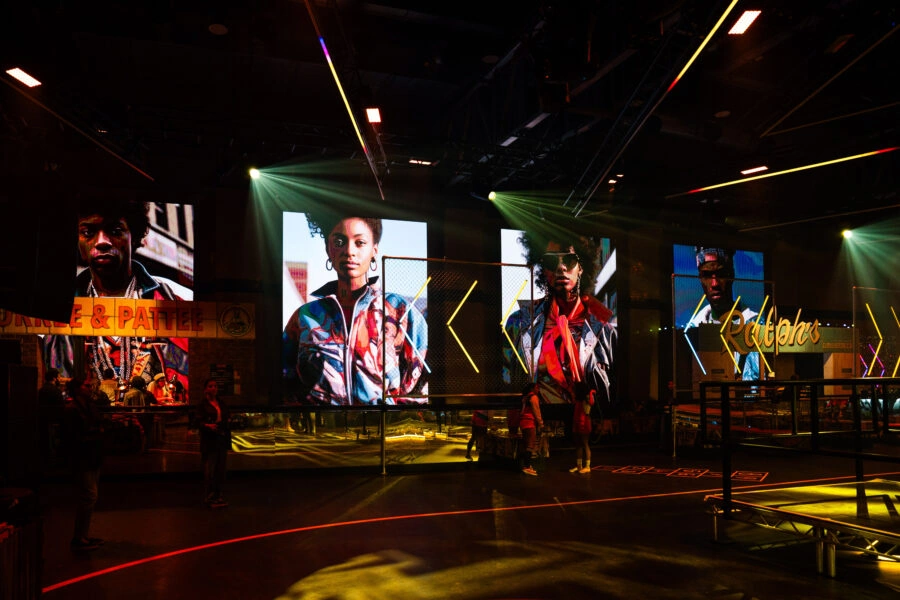 Wide view of the basketball court set, portrait screens and lighting at Exhibition London