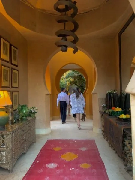 Two people walking through an arched passage during a Marrakech venue visit
