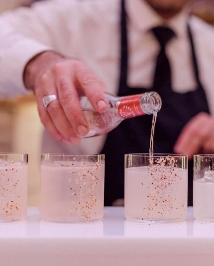A bartender pouring a drink at a luxury London event by Sauveur Studios.