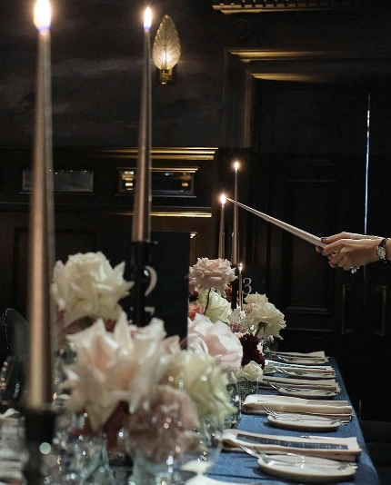 Candles being lit at a luxury wedding by event planner Sauveur Studios.