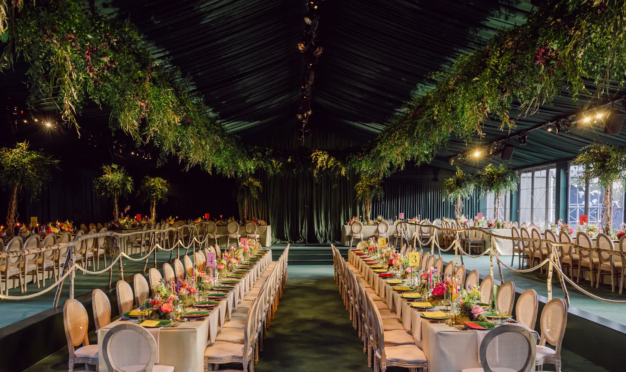 A colourful woodland dinner designed for a luxury event by Sauveur Studios.