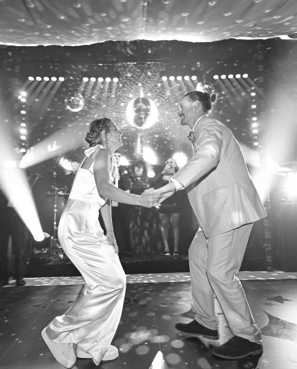 A couple doing their first dance in a marquee with luxury event production by Sauveur Studios.