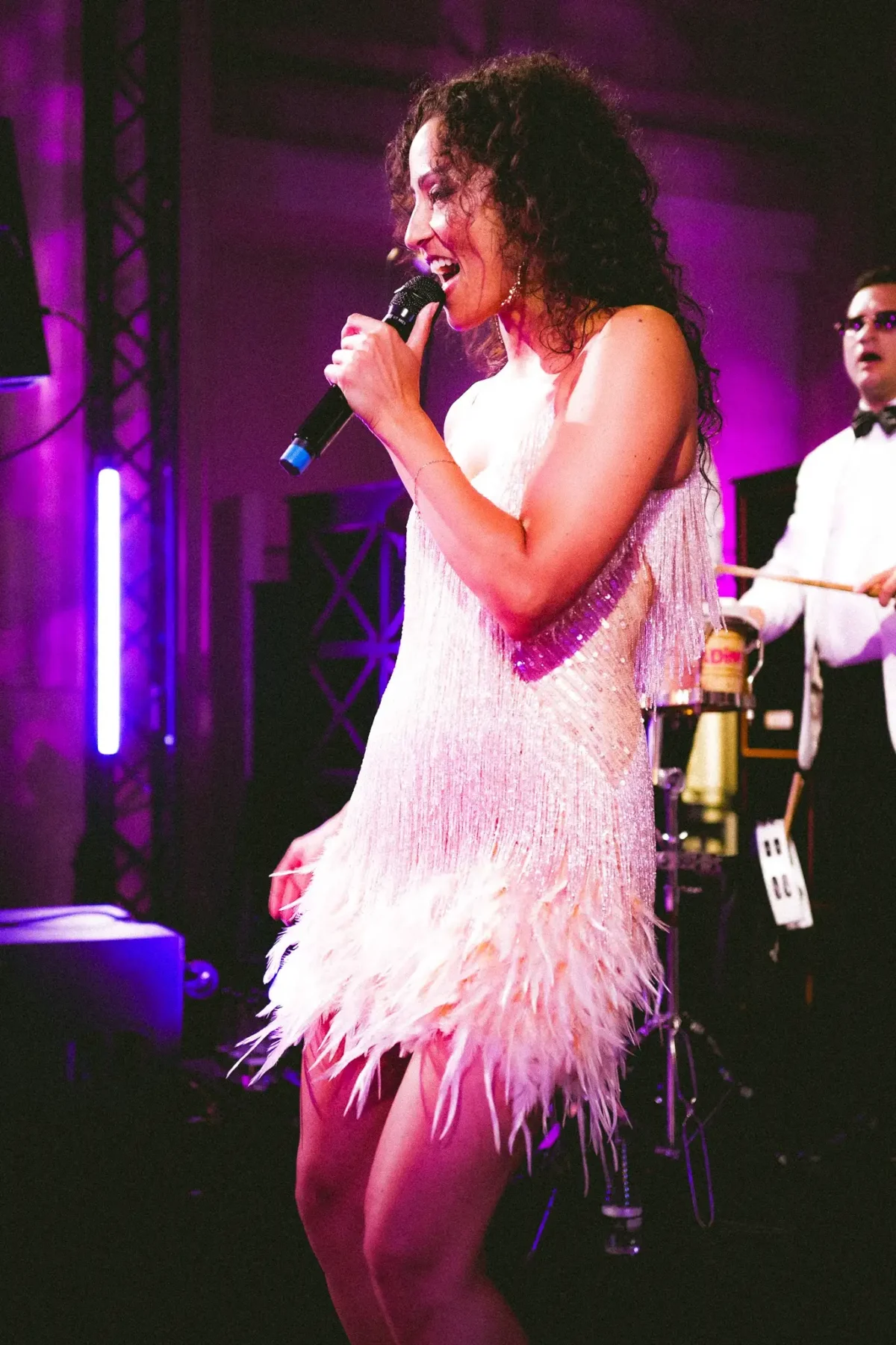A singer performs on stage at a birthday party created in London by Sauveur Studios.