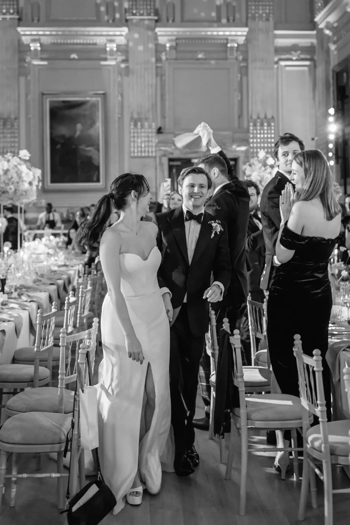 A couple entering dinner at a wedding produced by luxury wedding planner Sauveur Studios.