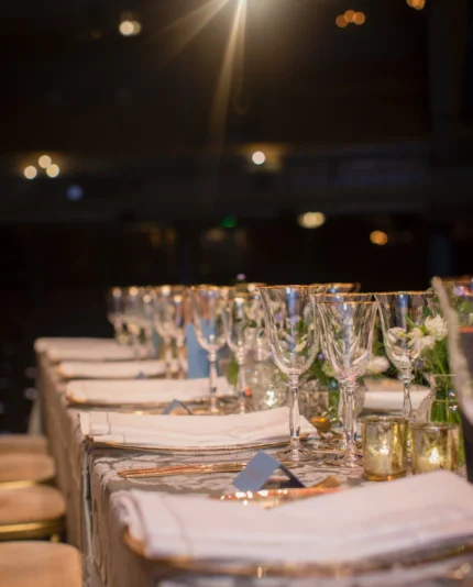 A dinner setup on a theatre stage in London with luxury event management by Sauveur Studios.