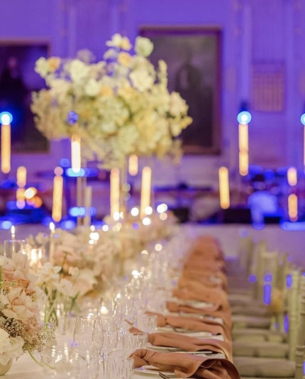 A long table setup with florals and luxury event production by wedding planner Sauveur Studios.