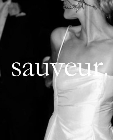 Black and white editorial photo of a bride with the logo of luxury event planners Sauveur Studios on top of the image.